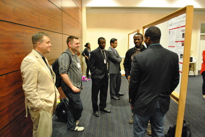 Students present posters to the other attendees